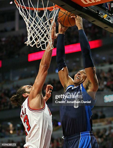 Shawn Marion of the Dallas Mavericks goes up for a dunk over Joakim Noah of the Chicago Bulls at the United Center on December 28, 2013 in Chicago,...