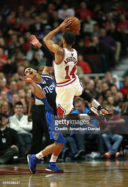 Augustin of the Chicago Bulls shoots over Shane Larkin of the Dallas Mavericks at the United Center on December 28, 2013 in Chicago, Illinois. NOTE...