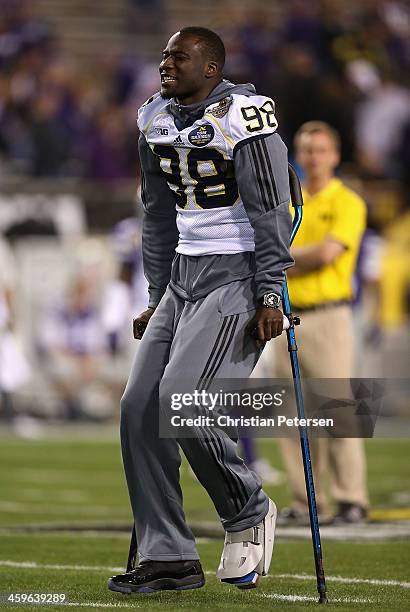 Quarterback Devin Gardner of the Michigan Wolverines watches warm ups before the Buffalo Wild Wings Bowl against the Kansas State Wildcats at Sun...