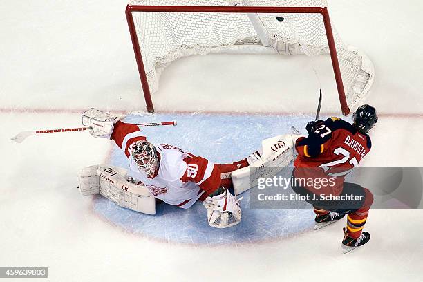 Nick Bjugstad of the Florida Panthers scores a goal against Goaltender Jonas Gustavsson of the Detroit Red Wings at the BB&T Center on December 28,...