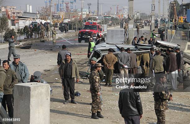 Afghan security officials inspect the site of a suicide bomb attack on a British embassy vehicle on November 27, 2014 in Kabul, Afghanistan....