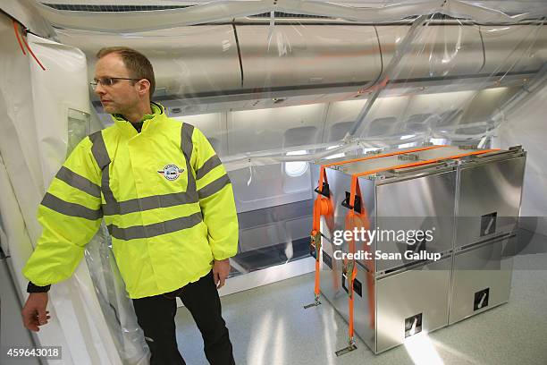 Dr. Christian Herzog, a volunteer and crew member from the Robert Koch Institute, stands in the isolation unit of a retrofitted Lufthansa plane...