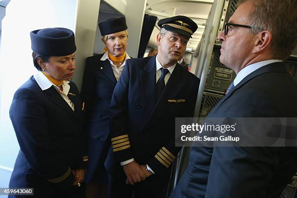 Volunteers of German airliner Lufthansa stand inside a retrofitted Lufthansa plane equipped with medical isolation facilities for Ebola cases during...