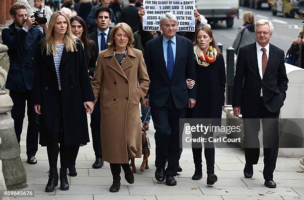 Andrew Mitchell , his wife Dr Sharon Bennett , family members and fellow parliamentarian David Davis arrive at the High Court on November 27, 2014 in...