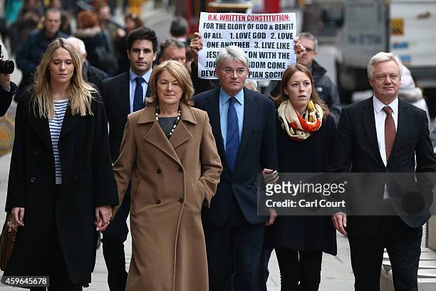Andrew Mitchell , his wife Dr Sharon Bennett , family members and fellow parliamentarian David Davis arrive at the High Court on November 27, 2014 in...