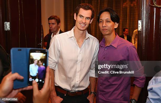 Andy Murray of the Manila Mavericks has a photograph taken with a fan as he arrives at the ITPA Gala dinner prior to the start of the Coca-Cola...