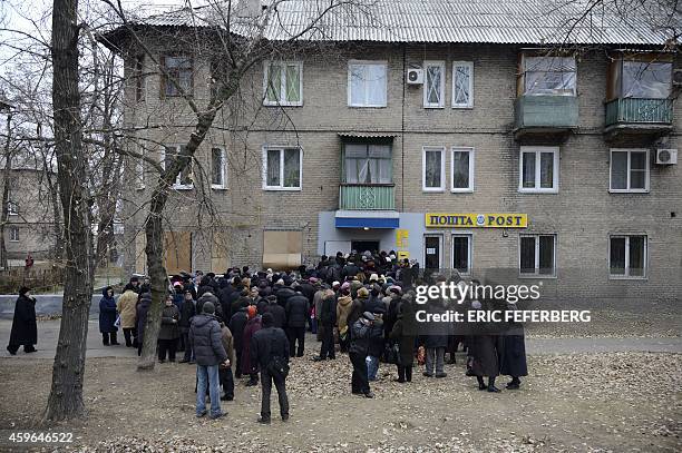 People wait in front of a post office to register to receive their pensions on November 27, 2014 after Urkrainian government suspended their payment...