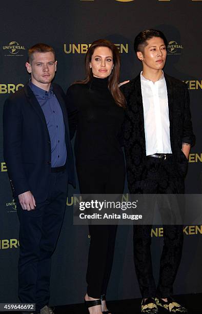 Jack O'Connell, Angelina Jolie and Miyavi attend the photocall for the film 'Unbroken' on November 27, 2014 in Berlin, Germany.