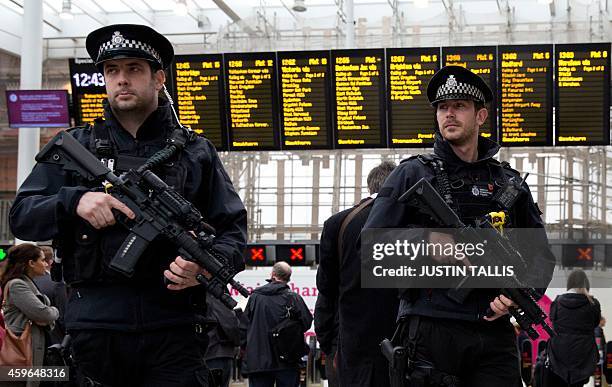 Armed officers from the British Transport Police patrol armed with LMT defender 5.56mm automatic rifles, 9mm Glock pistols and tasers as part of...