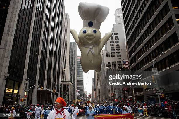 The Pillsbury Doughboy balloon floats on Sixth Avenue during the Macy's Thanksgiving Day Parade on November 27, 2014 in New York City. The annual...