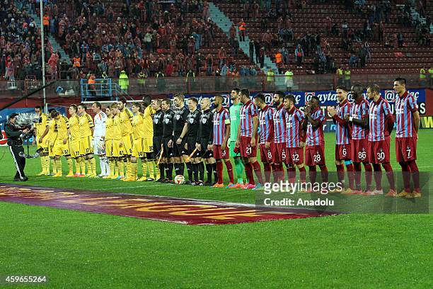 Trabzonspor and Metalisst Kharkiv football team stand prior to the UEFA Europa League Group L football match Trabzonspor vs Metalist Kharkiv at...