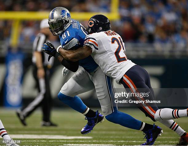 Calvin Johnson of the Detroit Lions tries to avoid the tackle by Ryan Mundy of the Chicago Bears in the second quarter at Ford Field on November 27,...