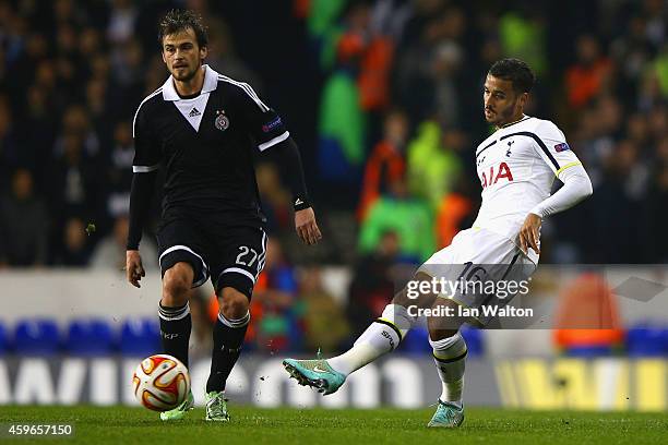 Kyle Naughton of Spurs passes under pressure from Danko Lazovic of Partizan Belgrade during the UEFA Europa League group C match between Tottenham...