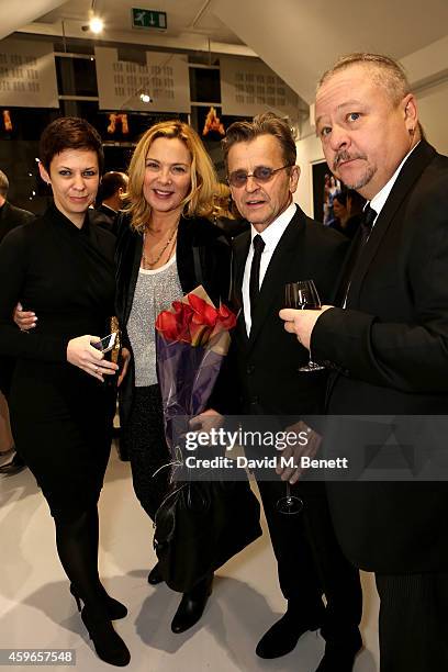 Artist Mikhail Baryshnikov and actress Kim Cattrall pose with guests as they attend Dancing Away, photographic exhibition by Mikhail Baryshnikov at...
