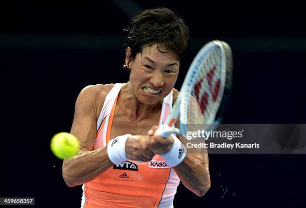 Kimiko Date-Krumm of Japan plays a backhand in her match against Olivia Rogowska of Australia during day one of the 2014 Brisbane International at...