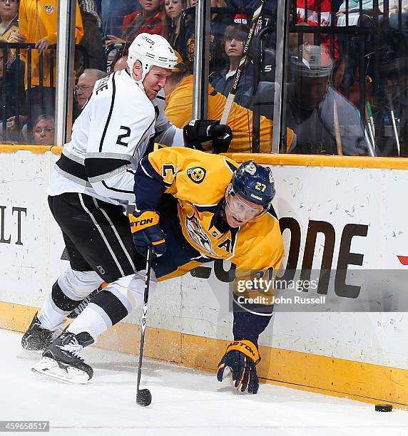 Matt Greene of the Los Angeles Kings battles along the boards against Patric Hornqvist of the Nashville Predators at Bridgestone Arena on December...