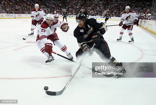 Teemu Selanne of the Anaheim Ducks is pursued by Oliver Ekman-Larsson of the Phoenix Coyotes for the puck in the third period at Honda Center on...