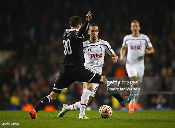 Branko Ilic of Partizan Belgrade tackles Nabil Bentaleb of Spurs during the UEFA Europa League group C match between Tottenham Hotspur FC and FK...