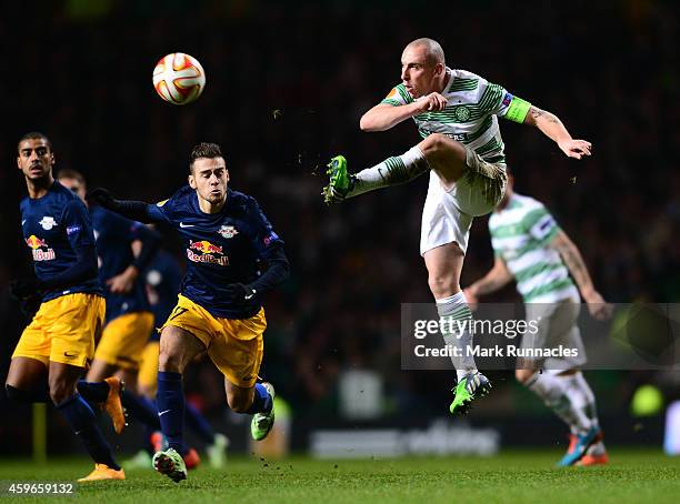 Scott Brown of Celtic keeps the ball moving past Massimo Bruno of FC Salzburg during the UEFA Europa League group D match between Celtic FC and FC...