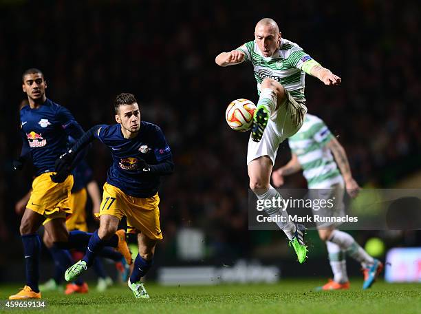 Scott Brown of Celtic keeps the ball moving past Massimo Bruno of FC Salzburg during the UEFA Europa League group D match between Celtic FC and FC...