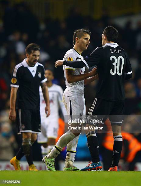 Erik Lamela of Spurs speaks to Branko Ilic of Partizan Belgrade during the UEFA Europa League group C match between Tottenham Hotspur FC and FK...