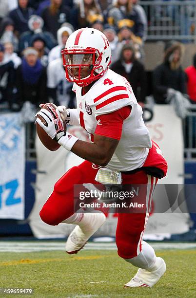 Tommy Armstrong Jr. #4 of the Nebraska Cornhuskers rolls out to pass against the Penn State Nittany Lions during the game on November 23, 2013 at...