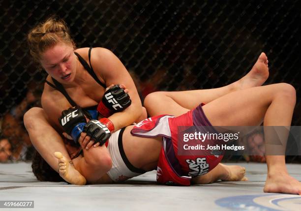 Ronda Rousey attempts to submit Miesha Tate in their UFC women's bantamweight championship bout during the UFC 168 event at the MGM Grand Garden...