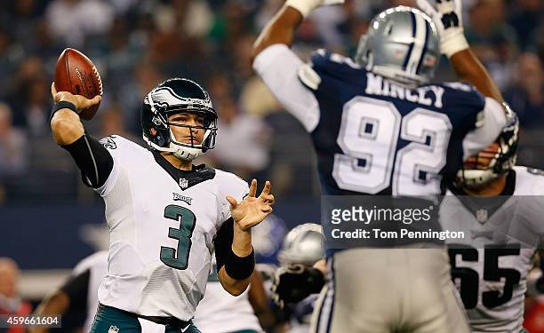 Mark Sanchez of the Philadelphia Eagles passes as Jeremy Mincey of the Dallas Cowboys applies pressure in the second half at AT&T Stadium on November...