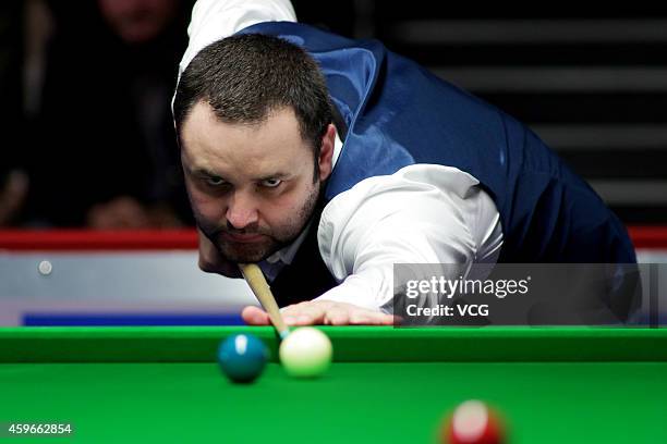 Stephen Maguire of Scotland plays a shot against Lu Ning of China on day three of the 2014 Coral UK Championship at York Barbican on November 27,...