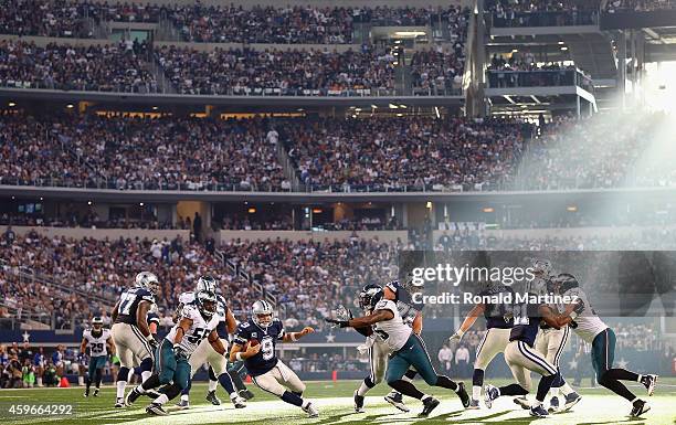 Tony Romo of the Dallas Cowboys holds the ball under pressure from the Philadelphia Eagles at Cowboys Stadium on November 27, 2014 in Arlington,...