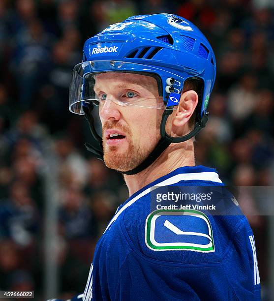 Henrik Sedin of the Vancouver Canucks looks on from the bench during their NHL game against the New Jersey Devils at Rogers Arena November 23, 2014...