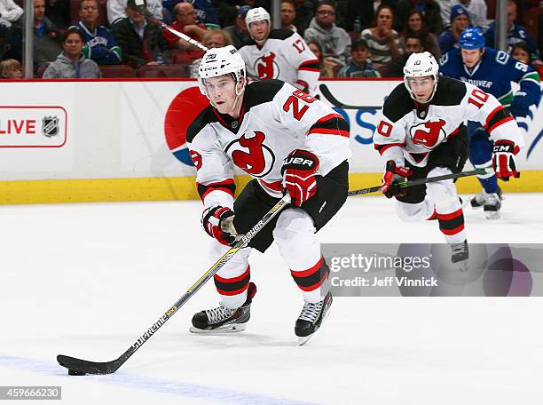 Damon Severson of the New Jersey Devils skates up ice with the puck during their NHL game against the Vancouver Canucks at Rogers Arena November 23,...