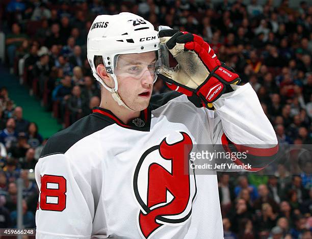 Damon Severson of the New Jersey Devils looks on from the bench during their NHL game against the Vancouver Canucks at Rogers Arena November 23, 2014...