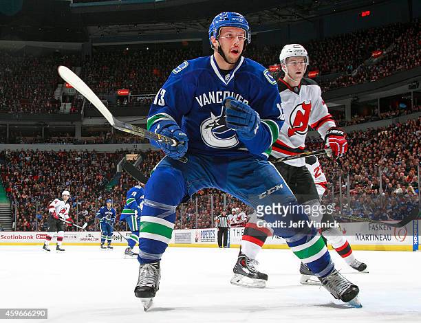 Nick Bonino of the Vancouver Canucks and Damon Severson of the New Jersey Devils watch for a rebound during their NHL game at Rogers Arena November...