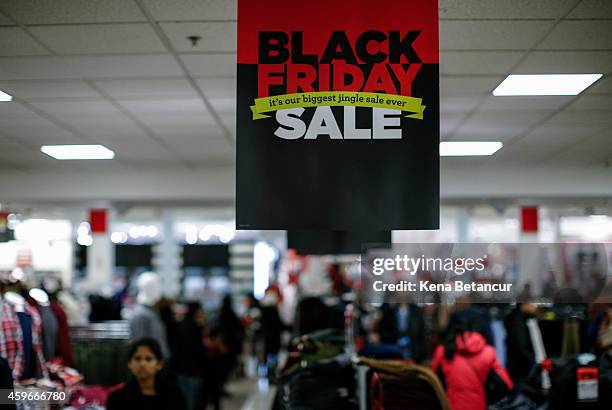 People shop at the JCPenney store at the Newport Mall on November 27, 2014 in Jersey City, New Jersey. Black Friday sales, which now begin on the...