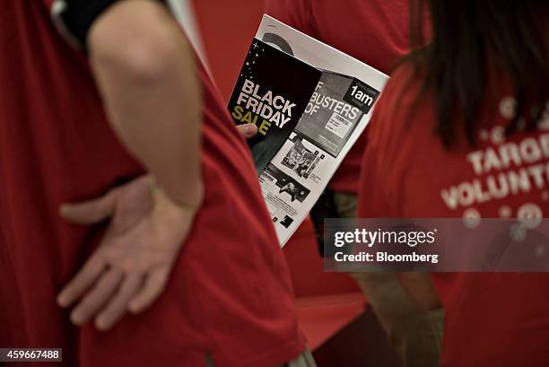 An employee holds a store map at a Target Corp. Store ahead of Black Friday in Mentor, Ohio, U.S., on Thursday, Nov. 27, 2014. An estimated 140...