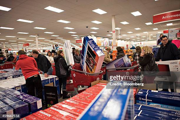 Customers load televisions into shopping carts at a Target Corp. Store ahead of Black Friday in Mentor, Ohio, U.S., on Thursday, Nov. 27, 2014. An...