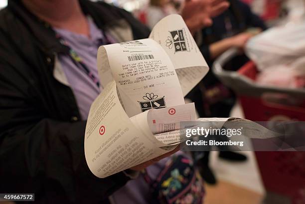 Customer holds a handful of gift receipts after paying for items at a Target Corp. Store ahead of Black Friday in Mentor, Ohio, U.S., on Thursday,...