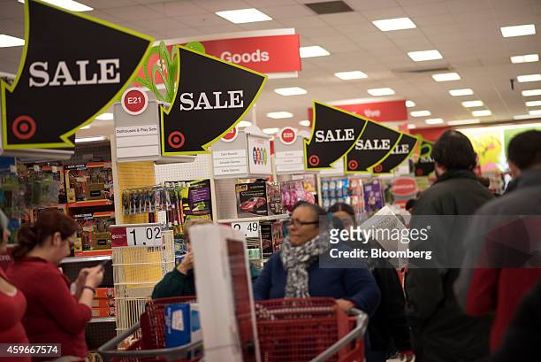 Sale signs hang above shoppers at a Target Corp. Store ahead of Black Friday in Mentor, Ohio, U.S., on Thursday, Nov. 27, 2014. An estimated 140...
