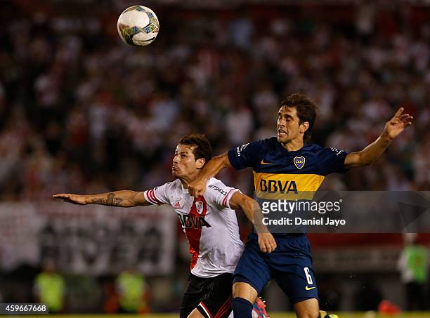 Juan Forlin, of Boca Juniors, and Rodrigo Mora, of River Plate, fight for the ball during a second leg semifinal match between River Plate and Boca...