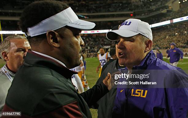 Texas A&M Aggies head coach Kevin Sumlin greets head coach Les Miles of the LSU Tigers on the field after the Tigers won 23-17 at Kyle Field on...