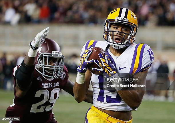 Malachi Dupre of the LSU Tigers hauls in a long pass in front of Deshazor Everett of the Texas A&M Aggies in the second half of their game at Kyle...