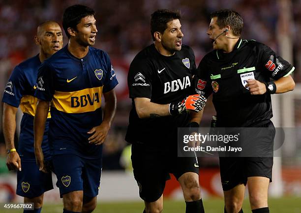 Daniel Diaz, of Boca Juniors, Leandro Marin, of Boca Juniors, and Agustin Orion, of Boca Juniors, complains to Referee German Delfino during a second...