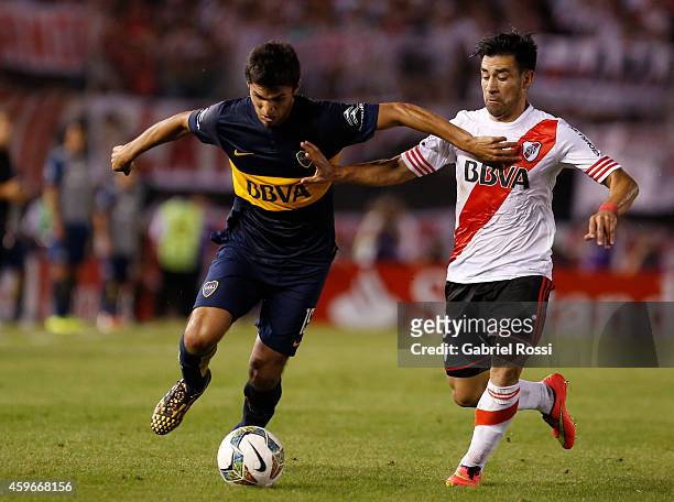 Leandro Marin of Boca Juniors fights for the ball with Ariel Rojas of River Plate during a second leg semifinal match between River Plate and Boca...