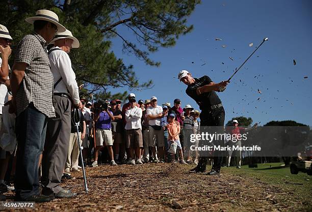 Brett Rumford of Australia plays out of the rough on the 18th hole during day two of the Australian Open at The Australian Golf Course on November...