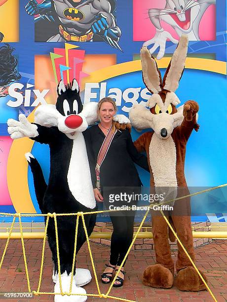 Uma Thurman is seen posing with Looney Tunes characters Sylvester and Wile E Coyote during her visit to Six Flags Great Adventure on June 10, 2012 in...