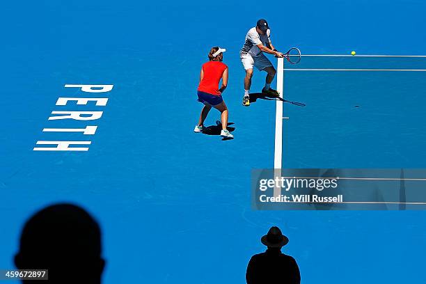 Daniel Munoz-De La Nava of Spain plays a forehand as Anabel Medina Garrigues looks on in the mixed doubles match against Petra Kvitova and Radek...