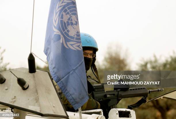 United Nations UNIFIL soldier from the Spanish contingent, sits in an armored vehicle after 20 the shells were fired by the Israeli army into...