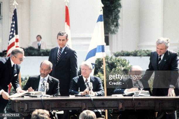 Egyptian President Anwar al-Sadat and Israeli Premier Menachem Begin , seated between US President Jimmy Carter, sign the historic US-sponsored peace...