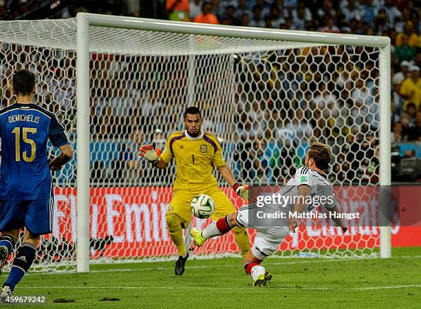 Mario Goetze of Germany scores his team's first goal past Sergio Romero of Argentina in extra time during the 2014 FIFA World Cup Brazil Final match...